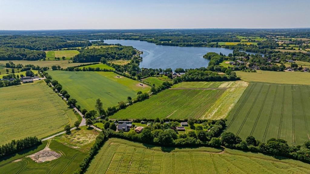 an aerial view of fields and a river at Nordisch Nest in Bistensee