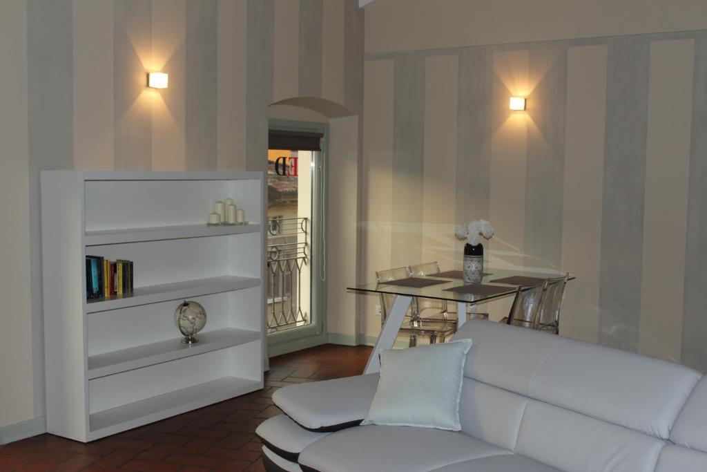 a living room with a white couch and a table at Eleganti Dimore in Brescia