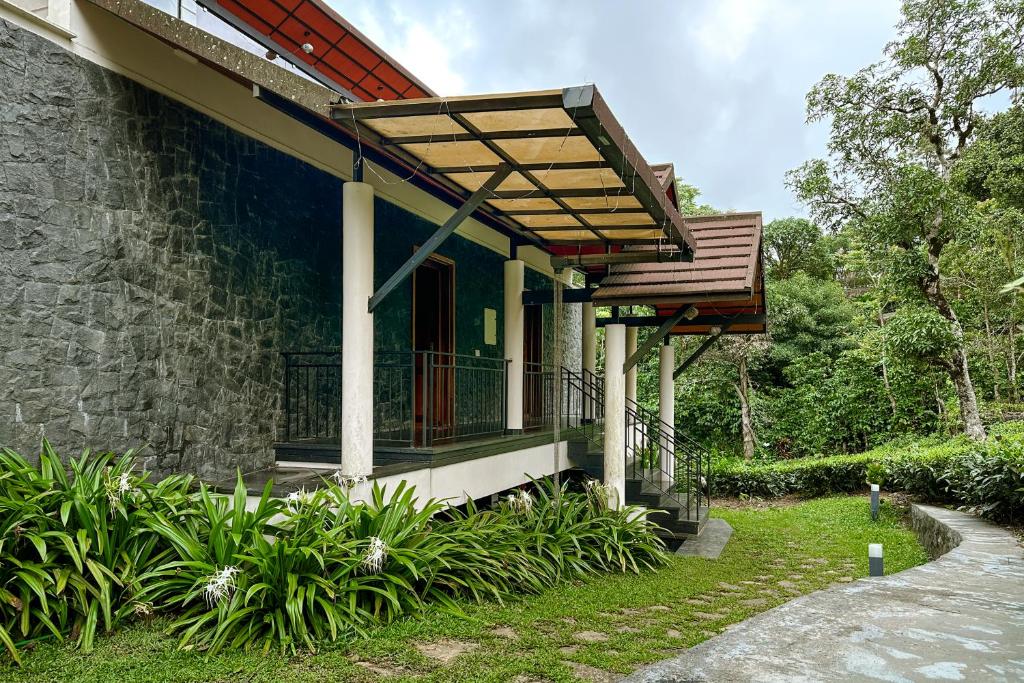 a building with a porch and a balcony at Serene Slopes in Vagamon
