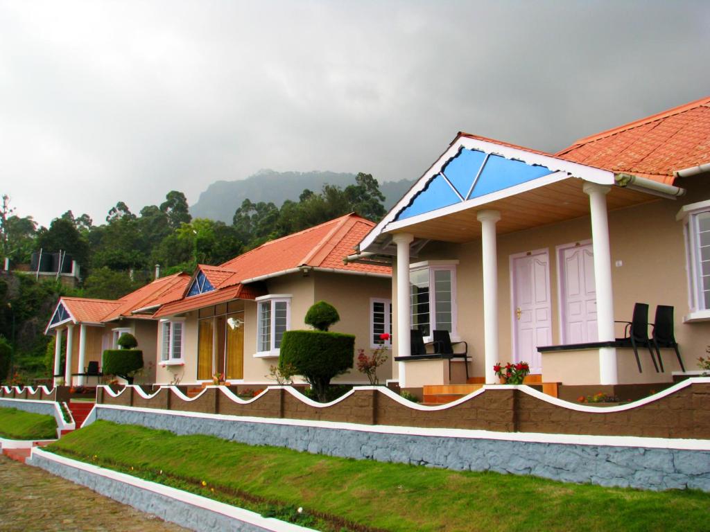 a row of houses with red roofs at Holiday Heaven Munnar in Chinnakanal