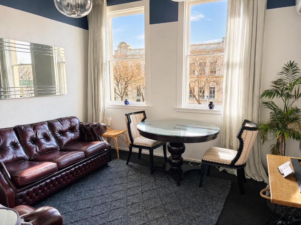 a living room with a couch and a table at The Opera View Suite in Oamaru