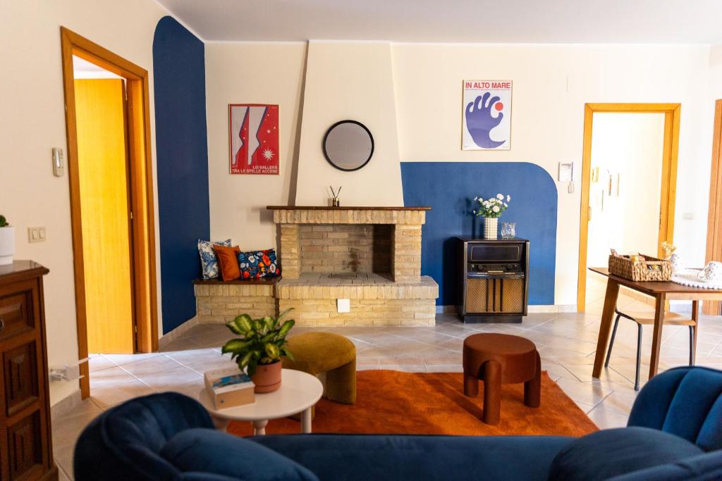 a living room with a couch and a fireplace at Casa Bottega in San Salvo