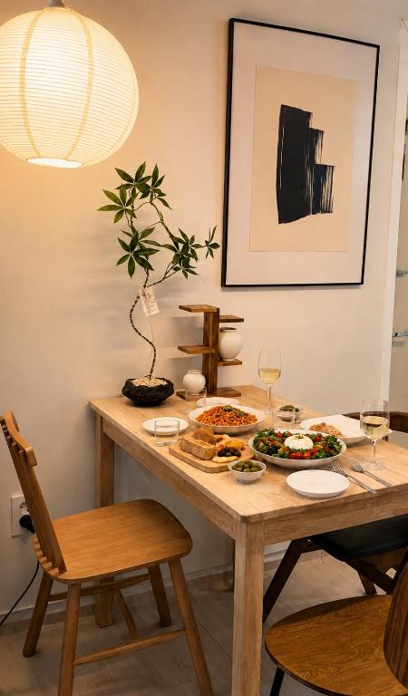 a dining room table with food and wine glasses at 헤이데이서울 in Seoul