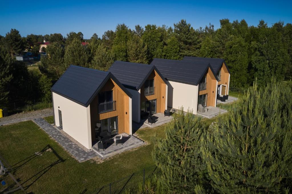 an overhead view of a row of houses with black roofs at Domki Beztroska Białogóra in Białogóra