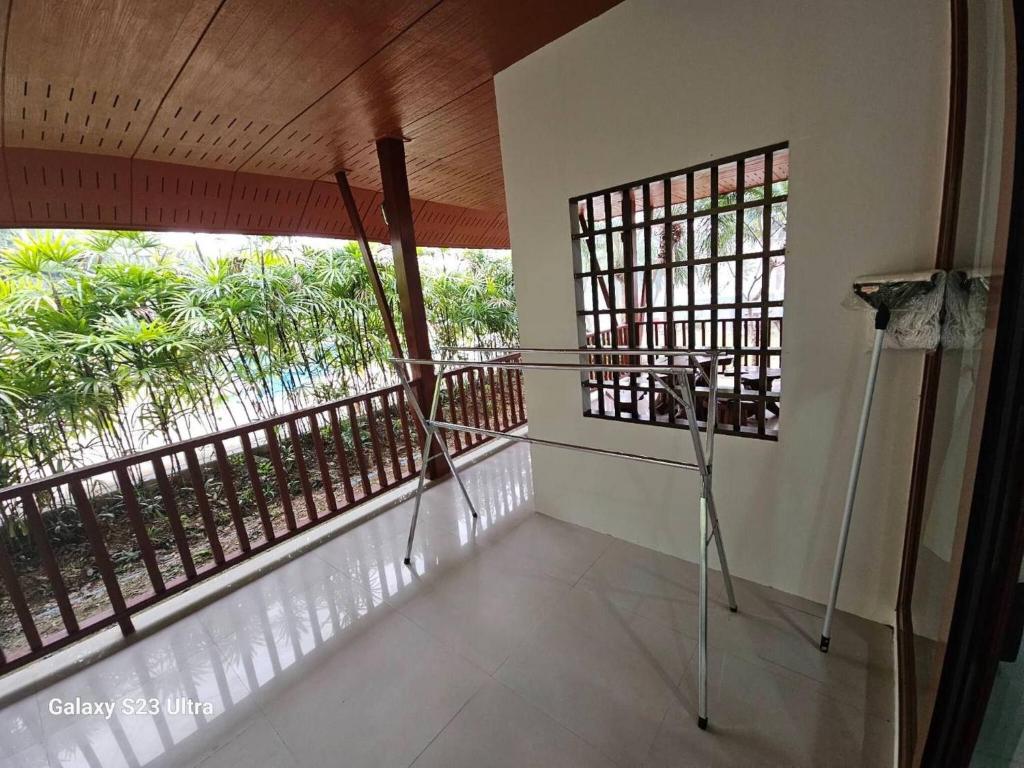a room with two windows and a balcony at Chaya village F shared pool jacuzzi in Phra Ae beach