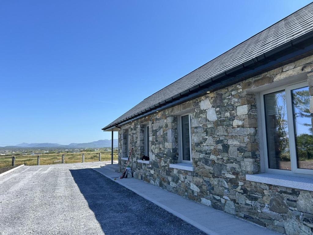 a stone building with a window on the side of it at Ballyconneely Lodge in Ballyconneely