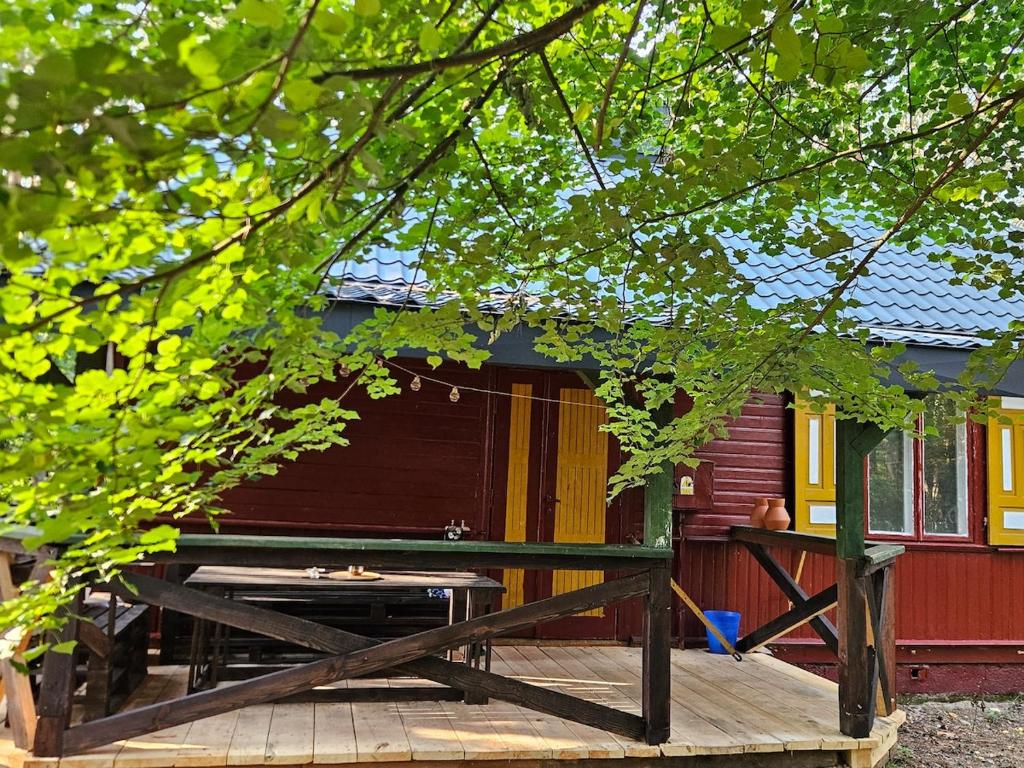 a house with a wooden deck in front of it at Leśna Kraina in Międzyrzec Podlaski
