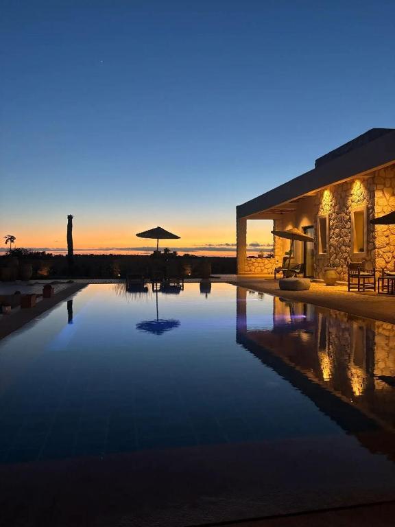 a house with a swimming pool at night at Tempo Vegan B&B in Essaouira