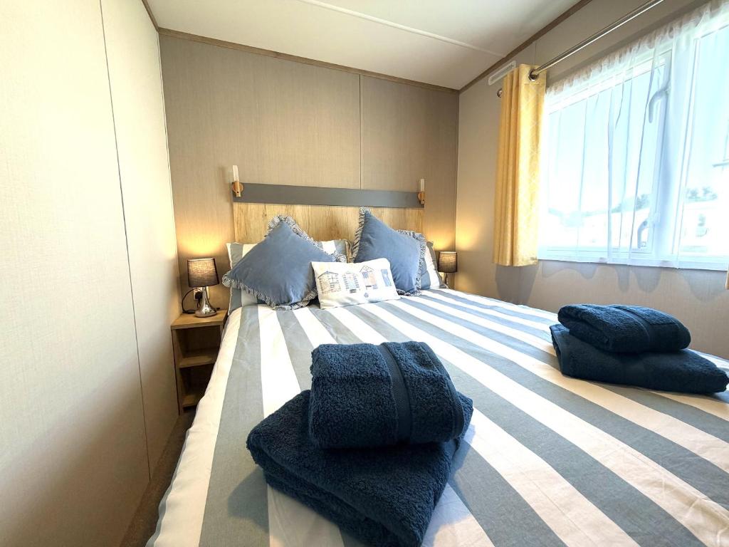 a bedroom with a bed with blue pillows on it at Gordy's Nook in Scarborough