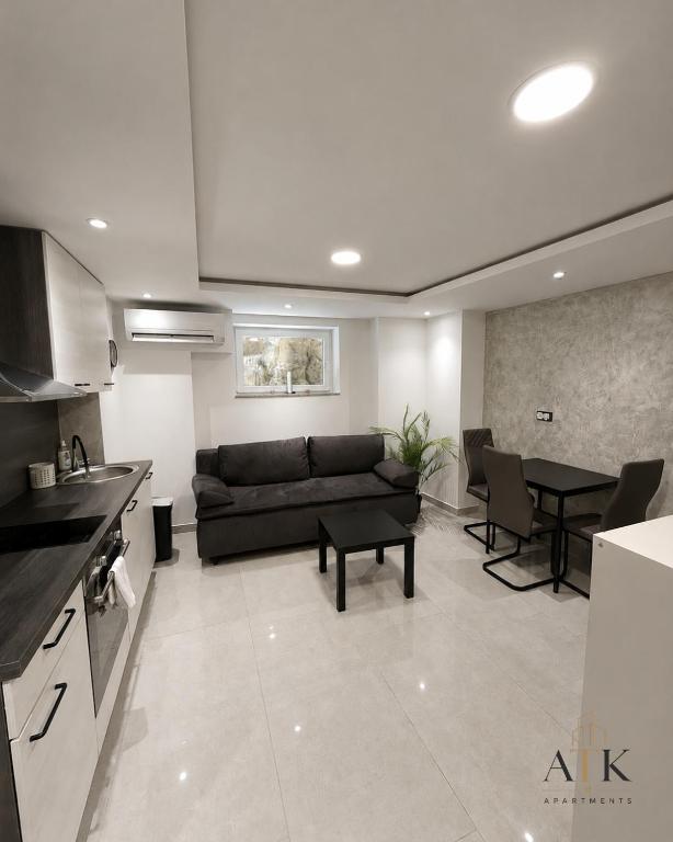 a living room with a couch and a table at ATK apartment in Koper