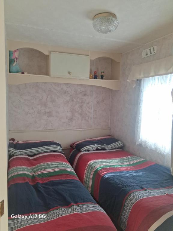 a room with two beds in a room at Mobile home in Liscannor