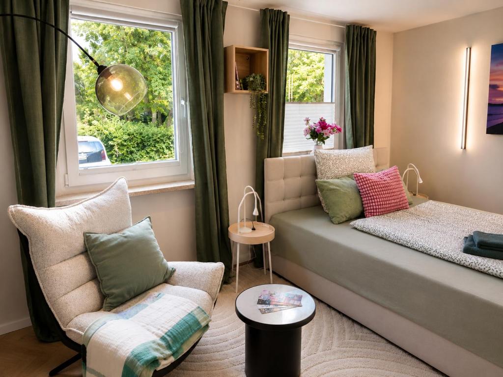 a small living room with a couch and a chair at Apartment am Innenstadtwall in Stadthagen