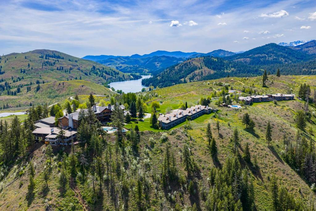 an aerial view of a house on a hill with a lake at Sun Mountain Lodge in Winthrop