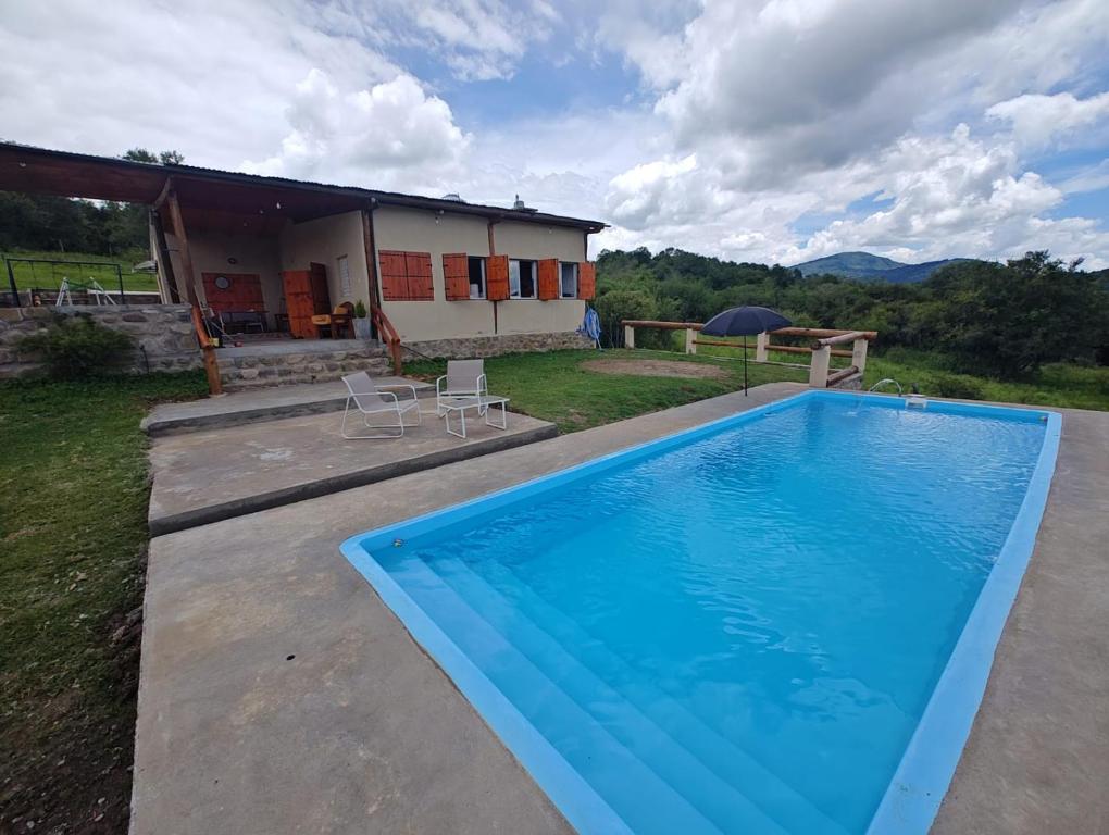 a large swimming pool in front of a house at La Paskana in La Caldera
