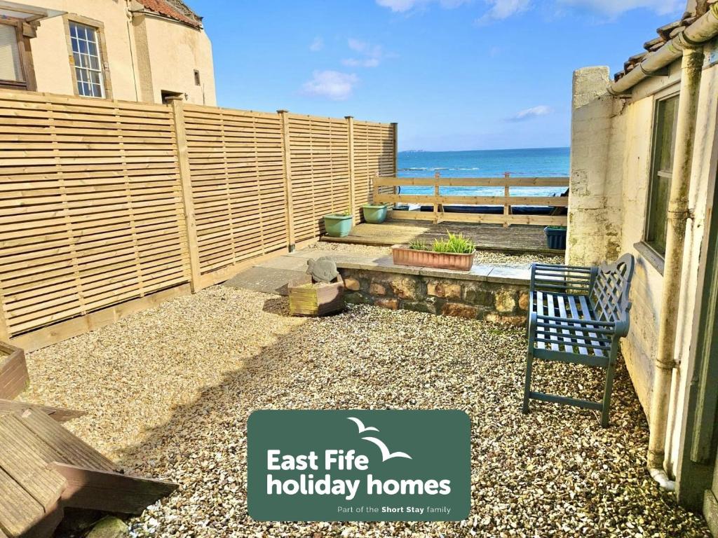 a house with a sign that reads east fire holiday homes at Little Net House - Pittenweem in Pittenweem