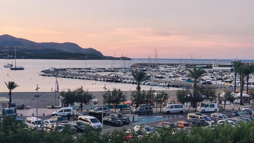 a parking lot with cars parked in a marina at Urpa Apartaments in Llança