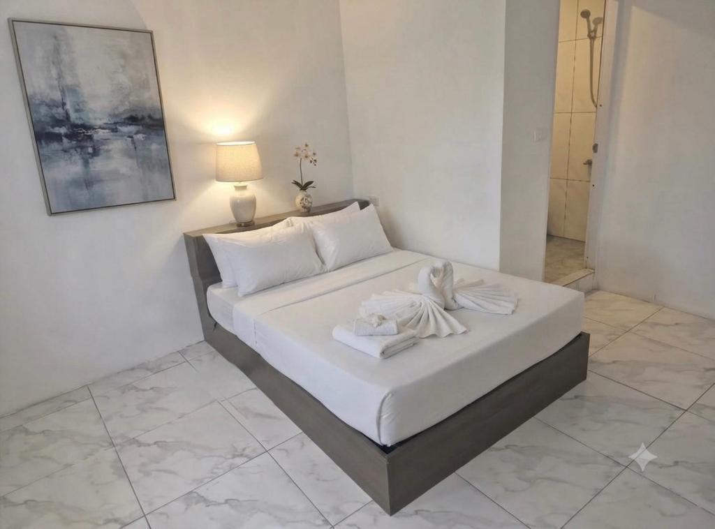 a white bed in a room with a lamp at SET Inn-2 in Kata Beach