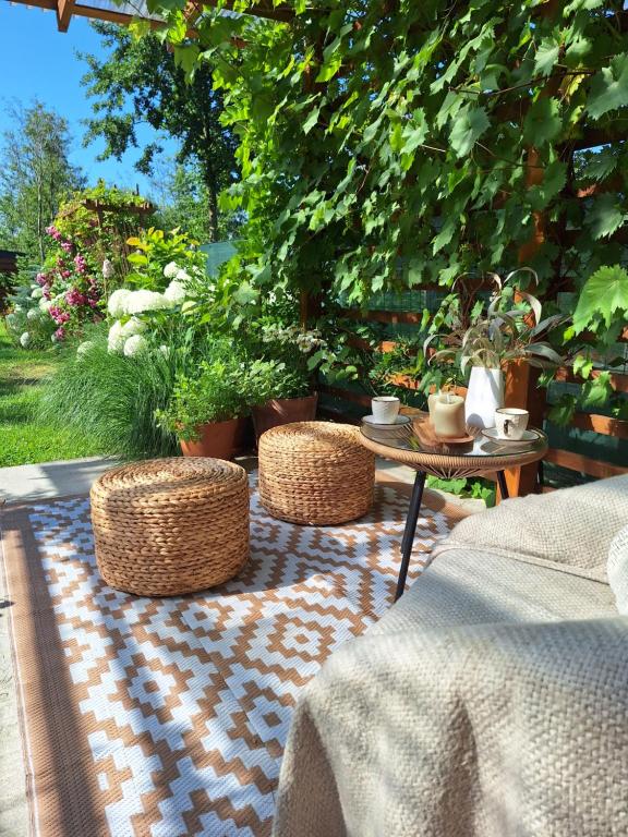 a patio with two chairs and a table with plants at Nadmorska Przystań in Gdańsk