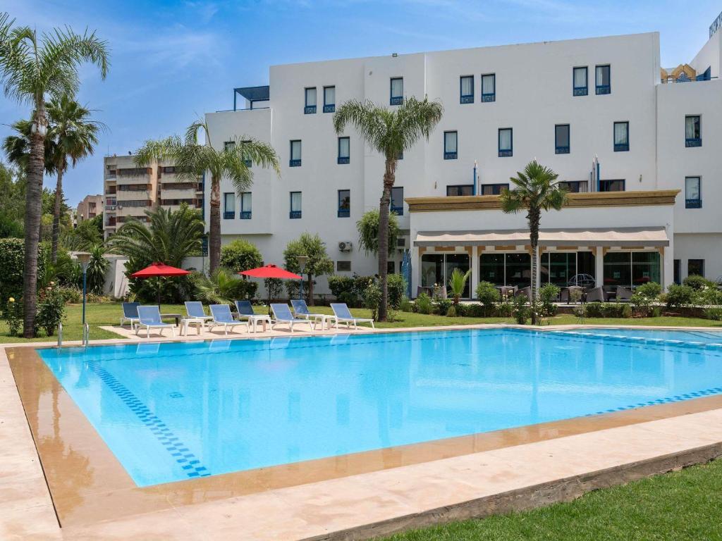 a large swimming pool in front of a hotel at Ibis Fes in Fez