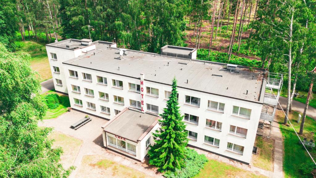 an overhead view of a white building with a tree at Minhauzena Unda in Saulkrasti