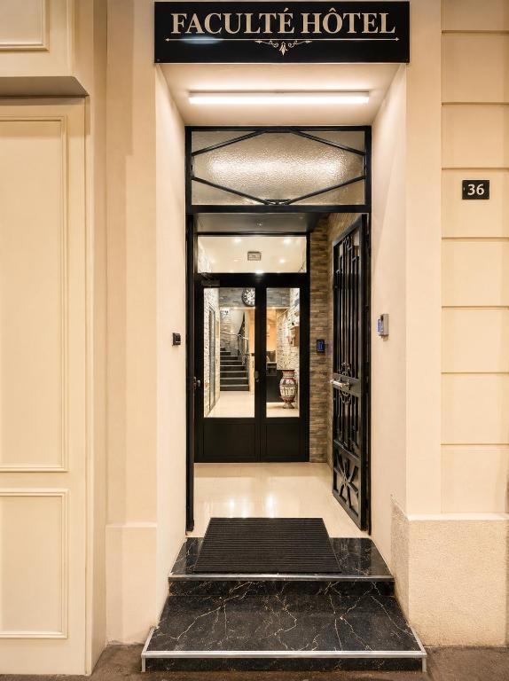 a front door of a hotel with a mat on the floor at Hôtel Faculté in Marseille