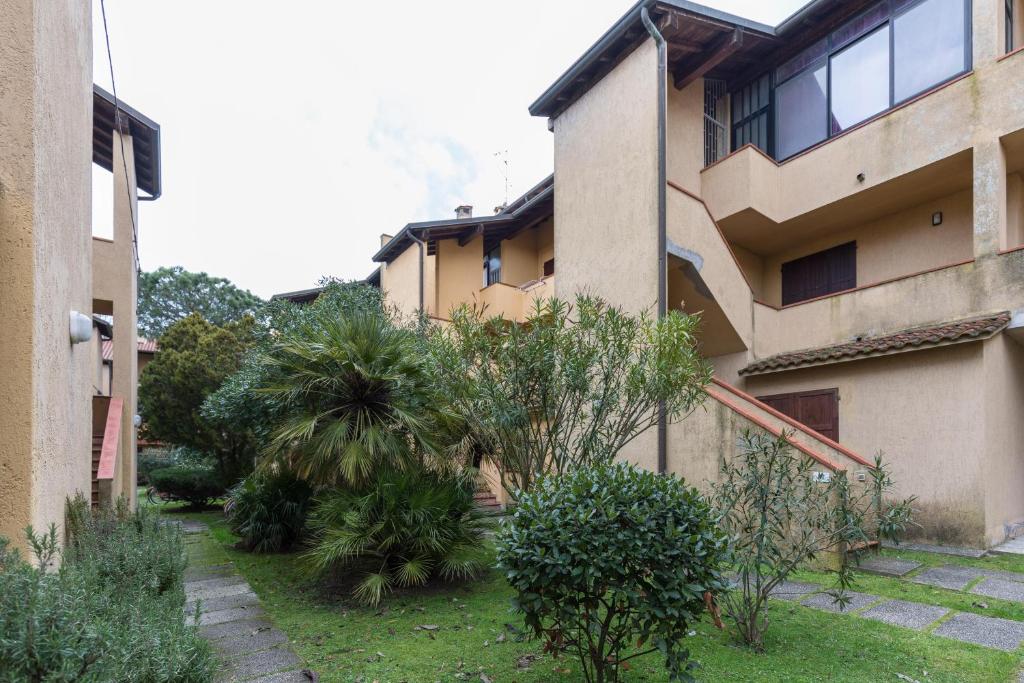 an apartment building with a garden in front of it at Apartment Ampio in Lido degli Estensi
