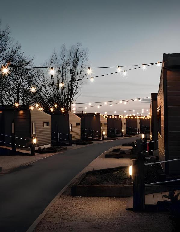a lit up street with a row of mobile homes with lights at Hideaway by Liv Retreats in Lincoln