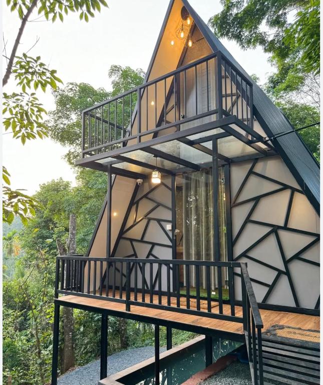 a house with a staircase up to the roof at The hideout peaks in Bhīm Tāl