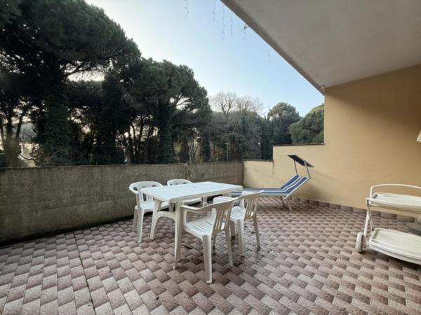 a patio with a table and chairs on a patio at Residenza Emilia in Lido degli Estensi