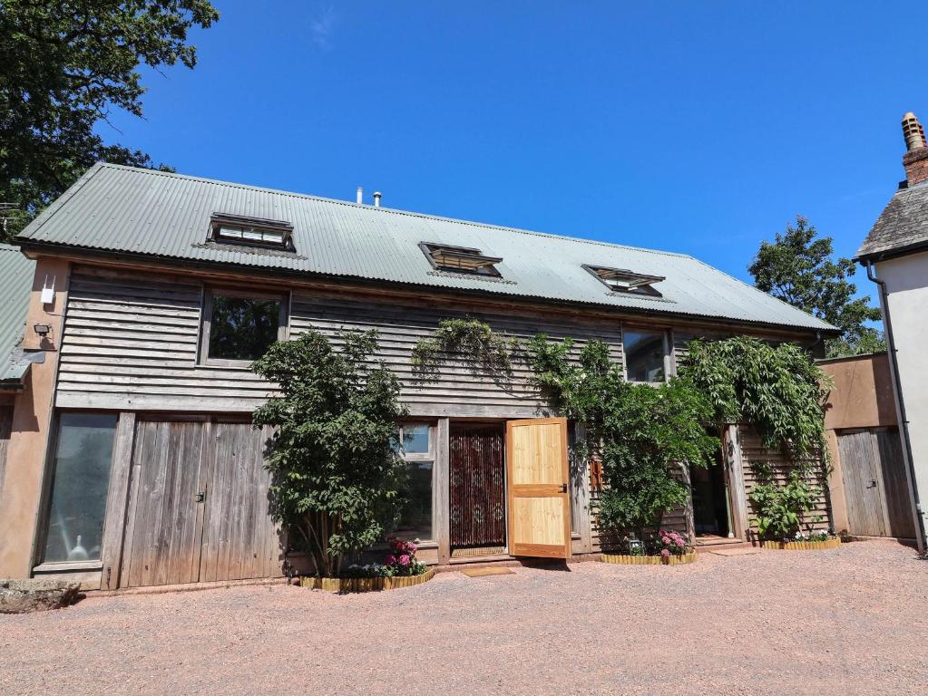 an old barn with a wooden door at Captains Barn in Tiverton