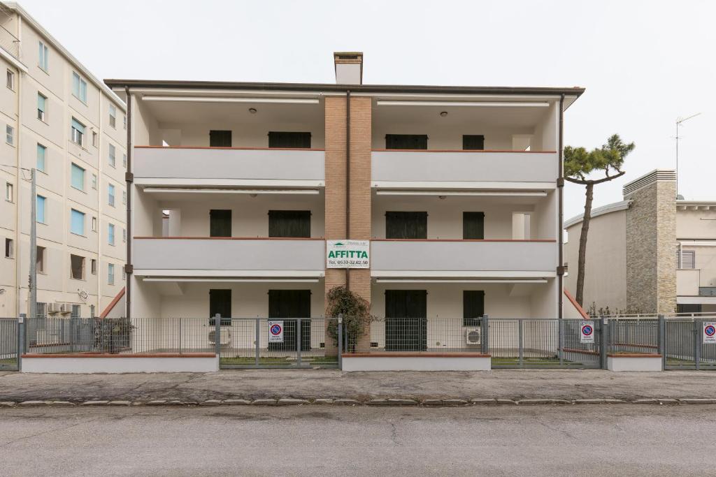 a white building with a fence in front of it at Smith 3B in Lido degli Estensi