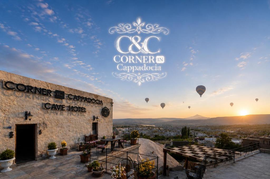 a sign for a conference pavilion with hot air balloons in the sky at Corner İn Cappadocia in Ortahisar