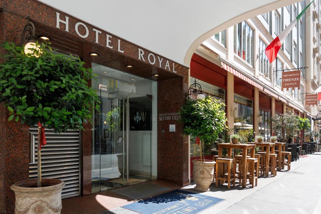a hotel lobby with tables and chairs on a street at Hotel Royal in Vienna