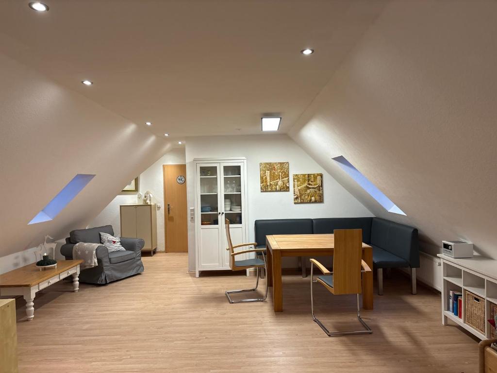 a living room with a table and a couch at Ferienwohnung Seestern-Ranch in Niederlangen