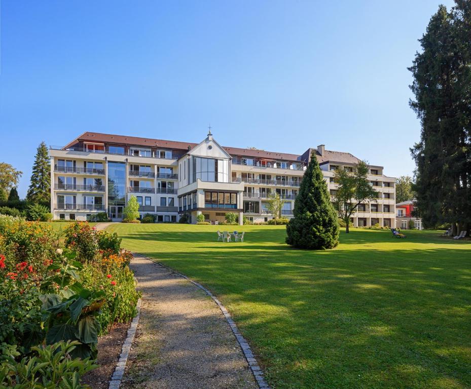 a large building in a park with a lawn at Kneippkurhaus St Josef in Bad Wörishofen