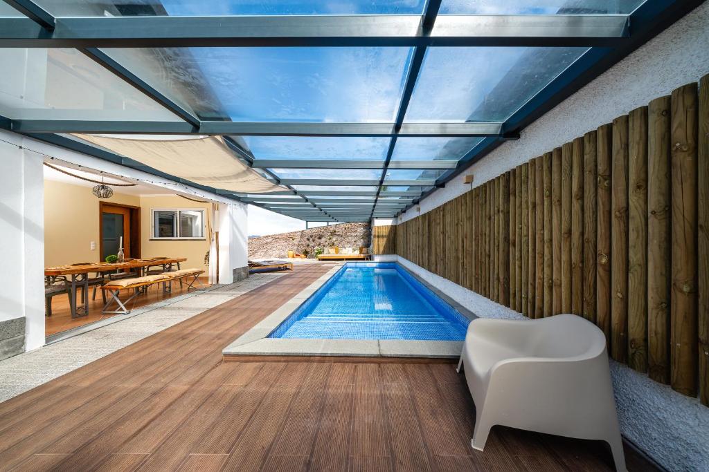 a swimming pool in the middle of a house at Villa Sea Colors by An Island Apart in Arco da Calheta