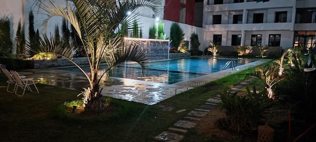 a swimming pool in the middle of a building at Martil , Lieu tranquille avec piscine in Martil