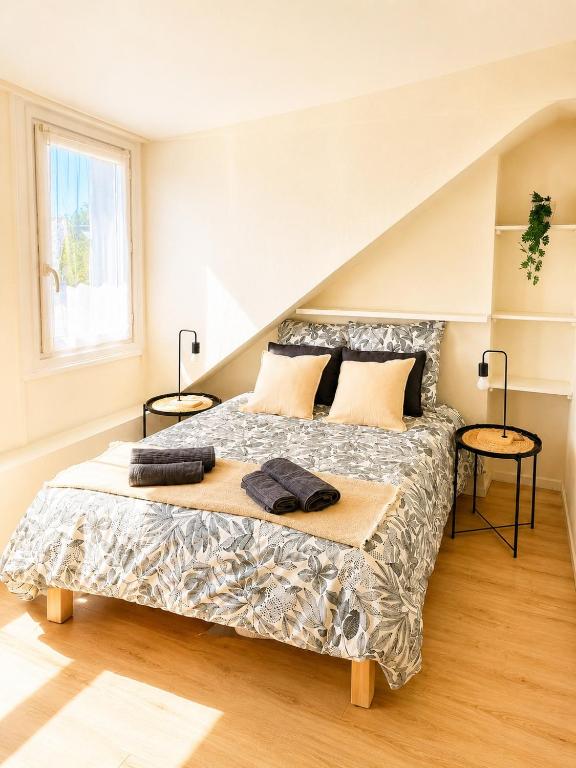 a bedroom with a large bed with two tables at L'Atelier 37 - Centre Tours in Tours