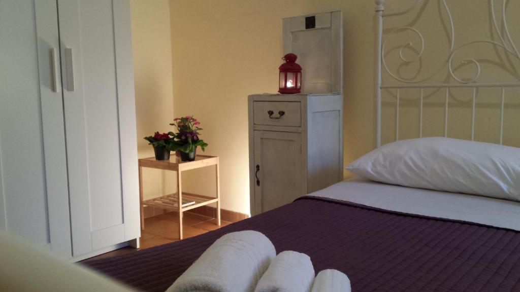 a bedroom with a bed and a dresser with a lamp at Appartamento Azzurra in Lecce