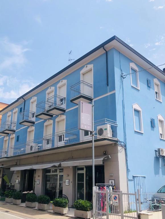 a blue building with balconies on a street at T Hotel- Adults Only, Pet Free Hotel in Rimini