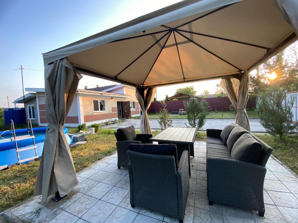 a large tent with chairs and a table and a table and chairs at Forest Edge house in Kolonshchina