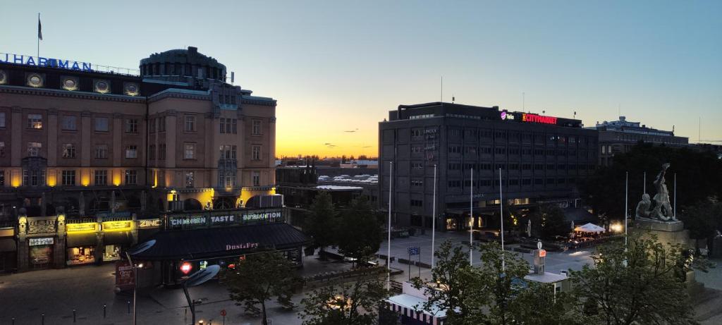 a view of a city at sunset with buildings at Ylätori 2A in Vaasa