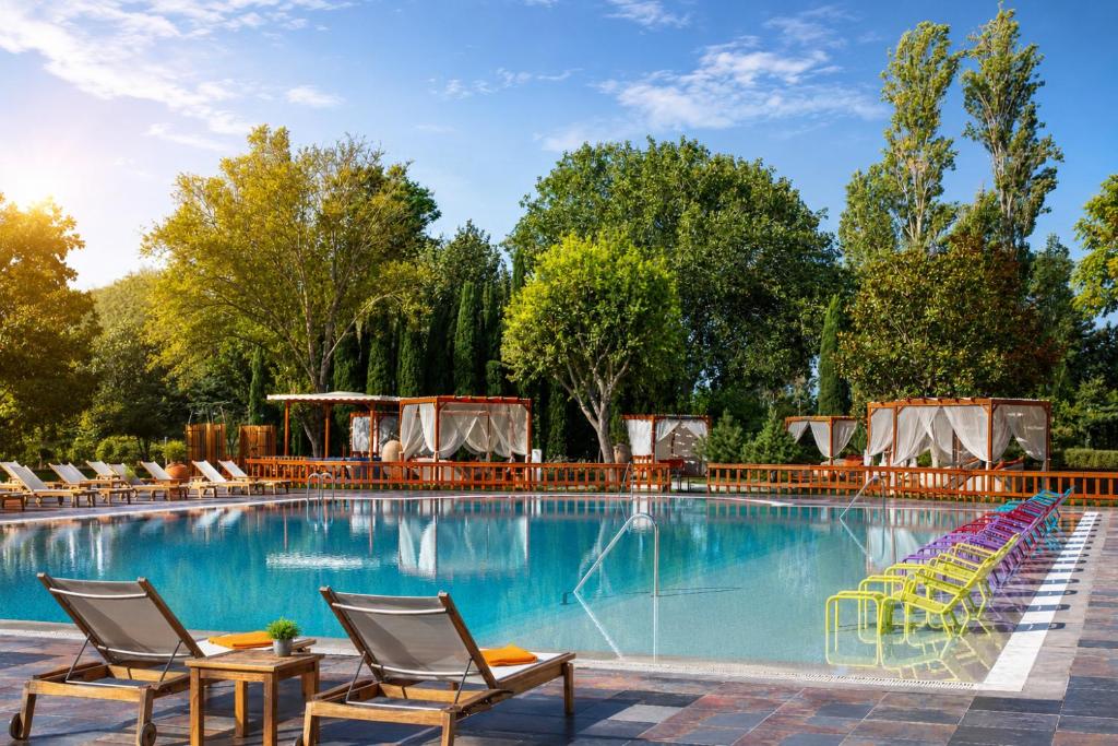 a swimming pool with lounge chairs and a resort at Sheraton Istanbul Atakoy Hotel in Istanbul