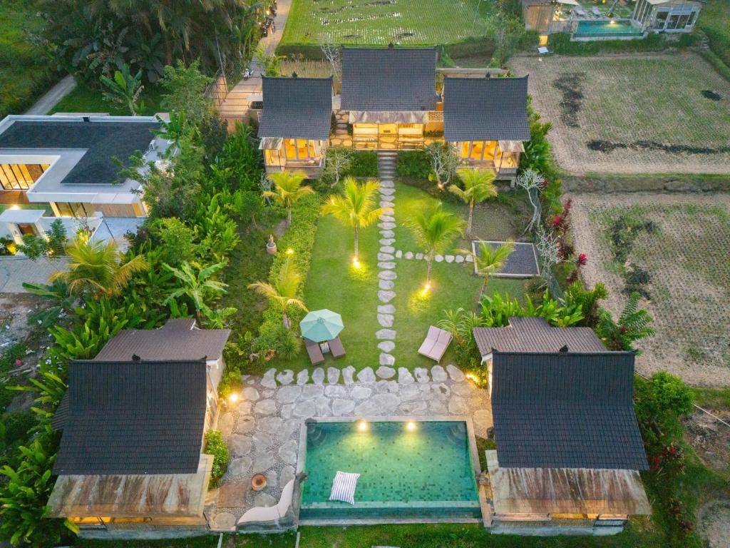 an aerial view of a house with a swimming pool at Sacred Padi Ubud Villa in Payangan