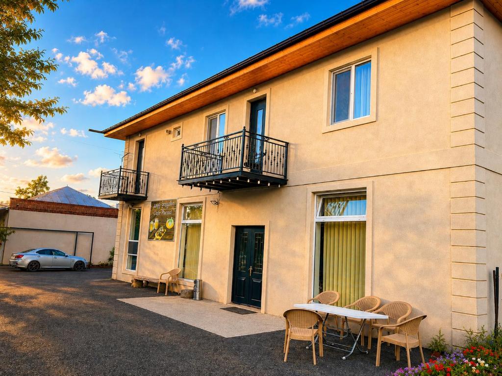 a house with a table and chairs in front of it at Paceri in Itʼkhvisi