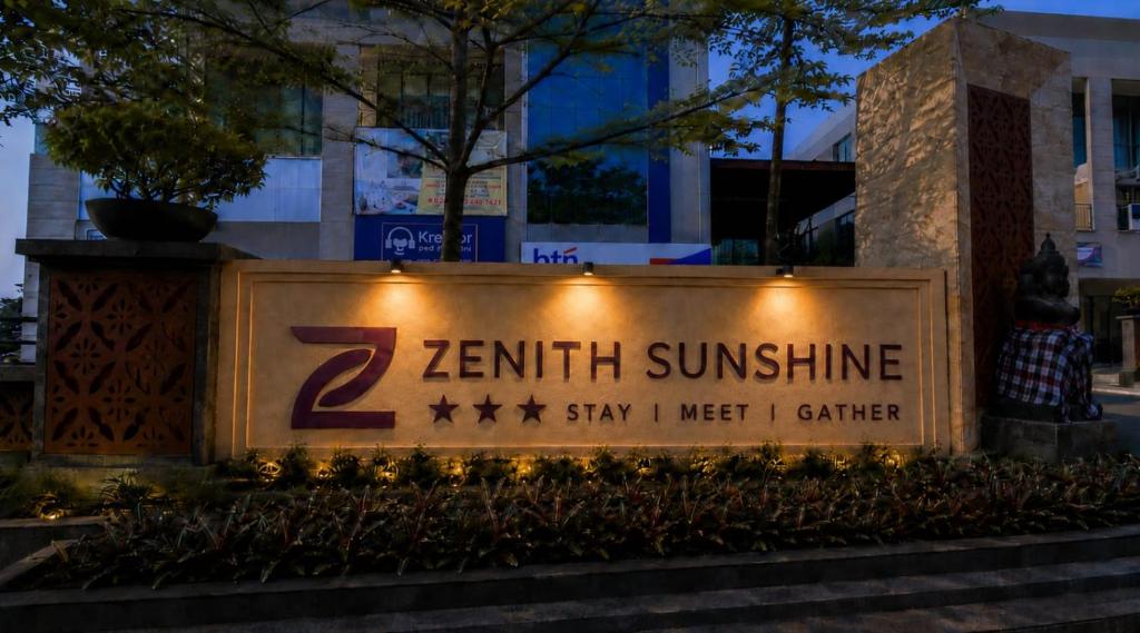 a sign in front of a building with lights at Zenith Sunshine in Lebakwangi