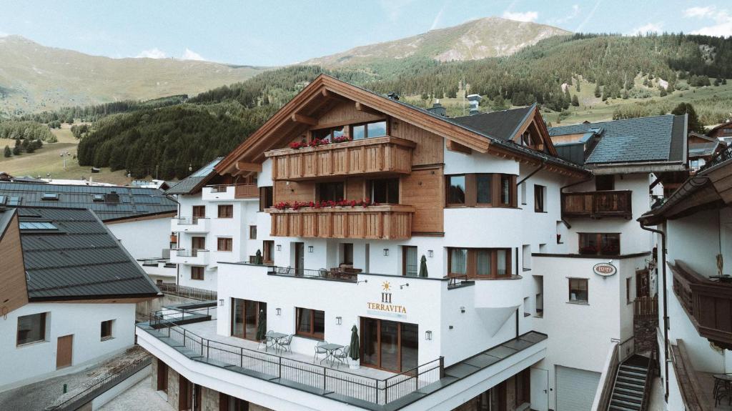 a building with wooden balconies on top of it at Terravita in Fiss