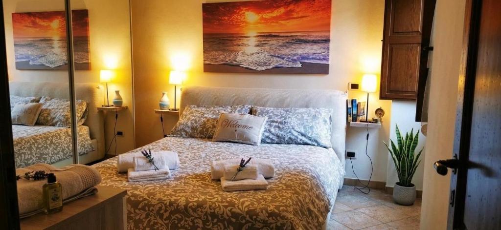 a bedroom with a bed with towels on it at Dimora Charme in Monterotondo