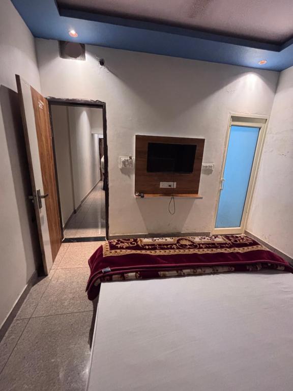 a room with a mirror and a tv on the wall at hotel happy ending in Hisār