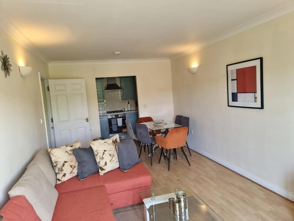 a living room with a couch and a dining room at Hunters Wharf River View by Select SA in Reading